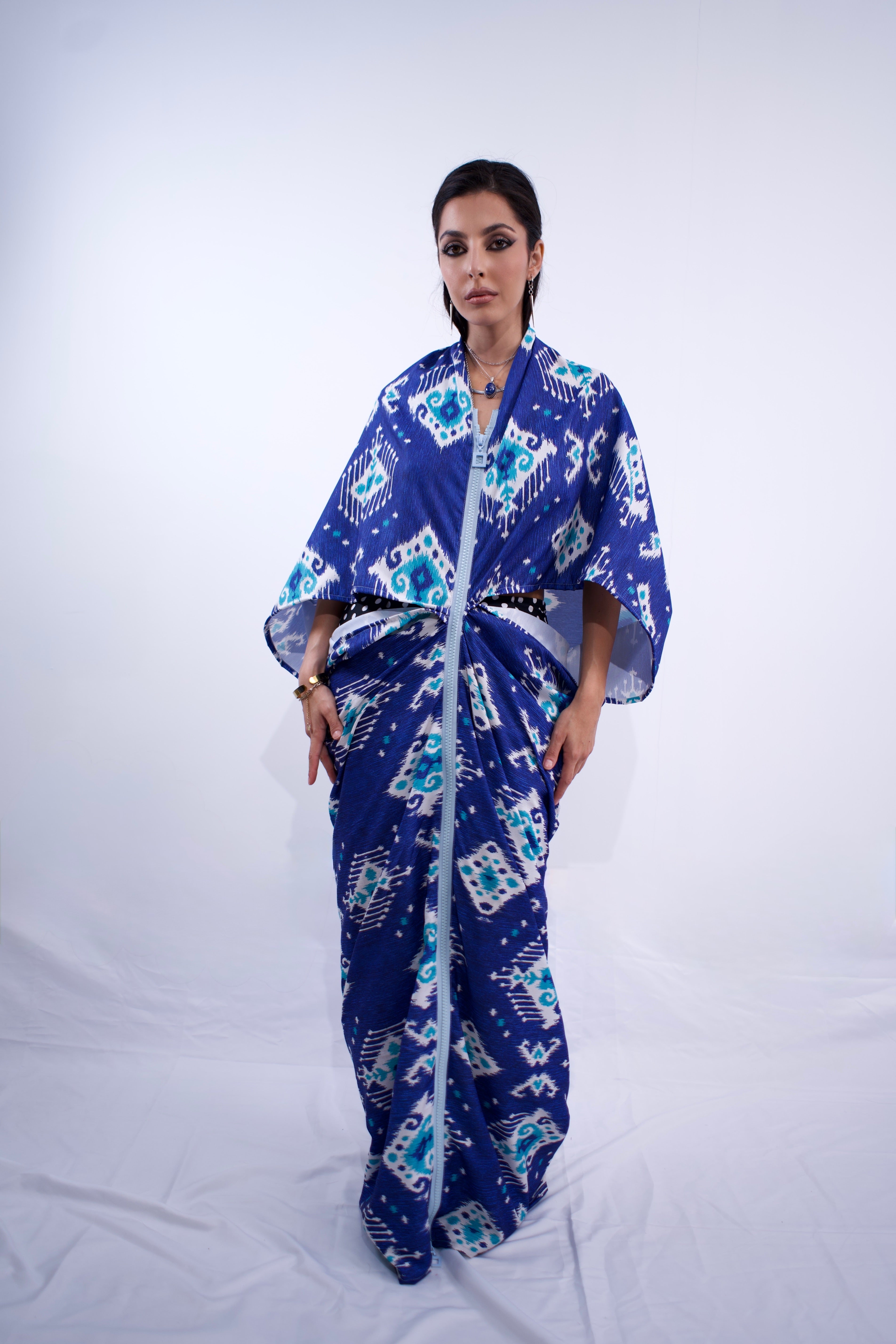 Woman wearing a blue patterned outfit on a white background