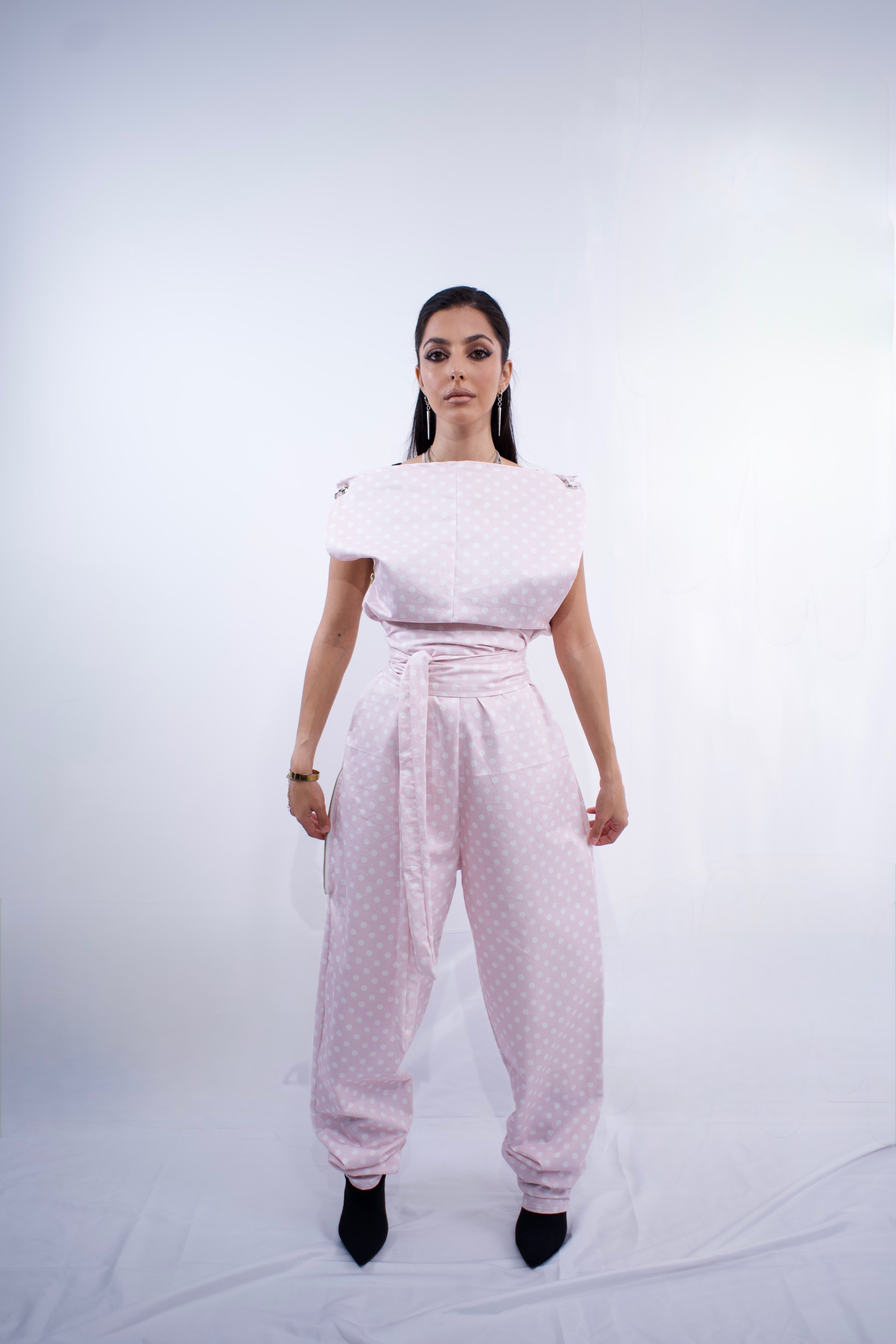 Switch Jumpsuit by MVATIS a convertible jumpsuit that transforms into sleek trousers with adjustable belt detail for cinched waist effect. 