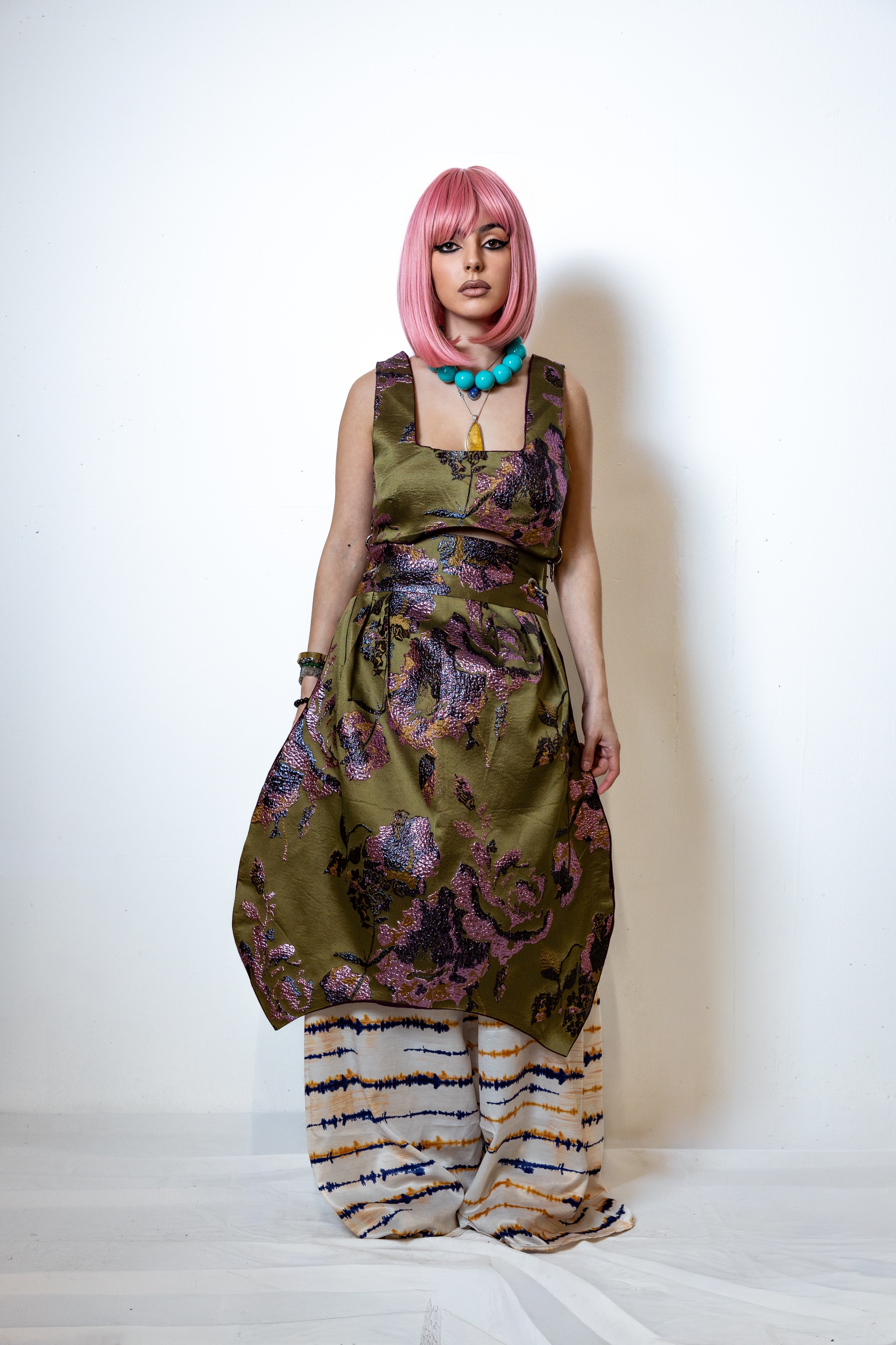 Person wearing a patterned dress with a white background