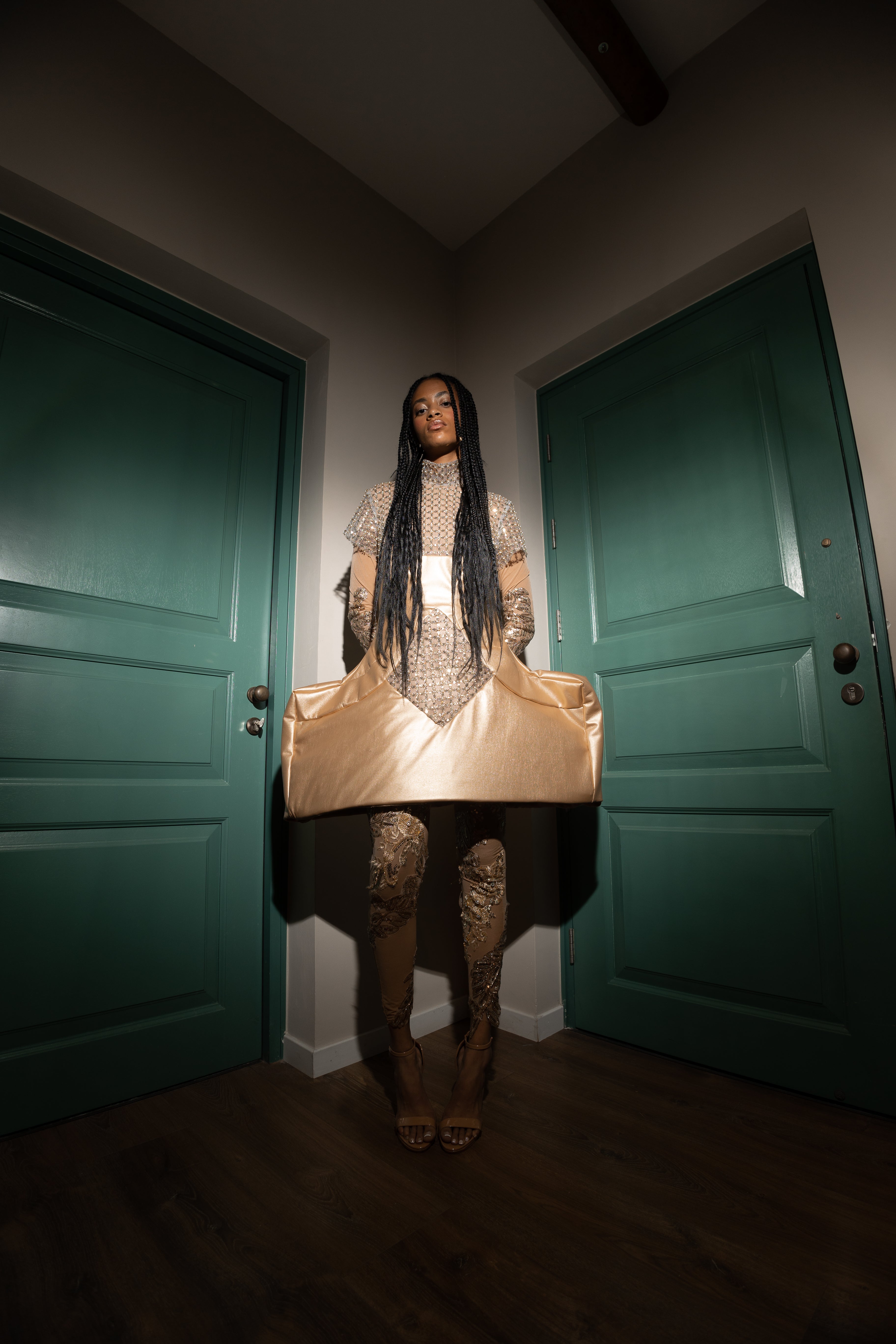 “Sculpted gold faux leather mini dress with intricate beading, featuring a form-fitting silhouette, structured bodice, and a glossy finish designed for the red carpet.”